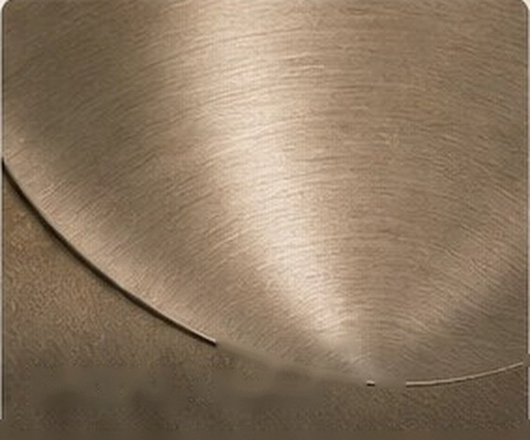 Refined metal surface with soft sheen